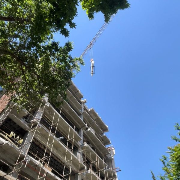 انتقال اسلب سنگ با جرثقیل به بالای ساختمان در حال ساخت